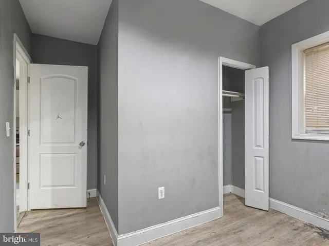 a view of an empty room with closet area