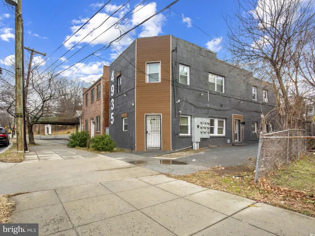 a front view of a building with a yard