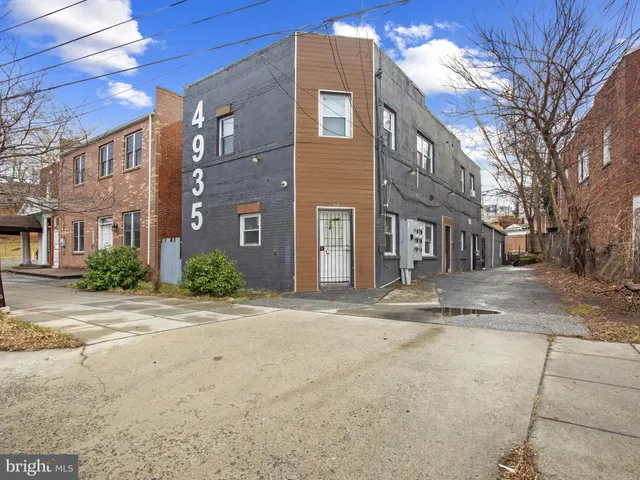 a view of a brick building next to a road