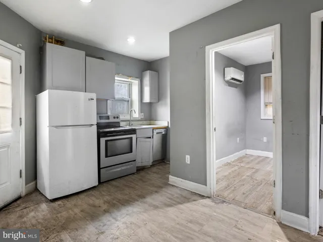 a kitchen with a refrigerator a sink and a stove top oven