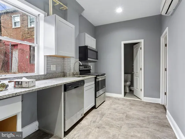 a kitchen with a sink stove and refrigerator