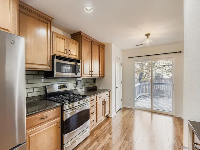 a picture of a bench in front of a white house