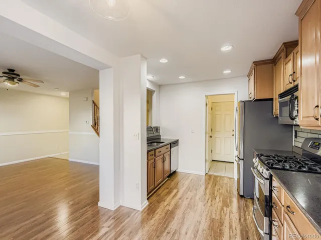 a kitchen with stainless steel appliances granite countertop a stove and a refrigerator