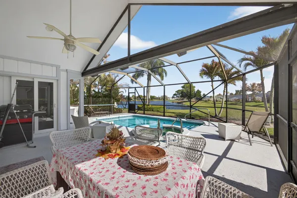 a view of swimming pool with outdoor seating and city view