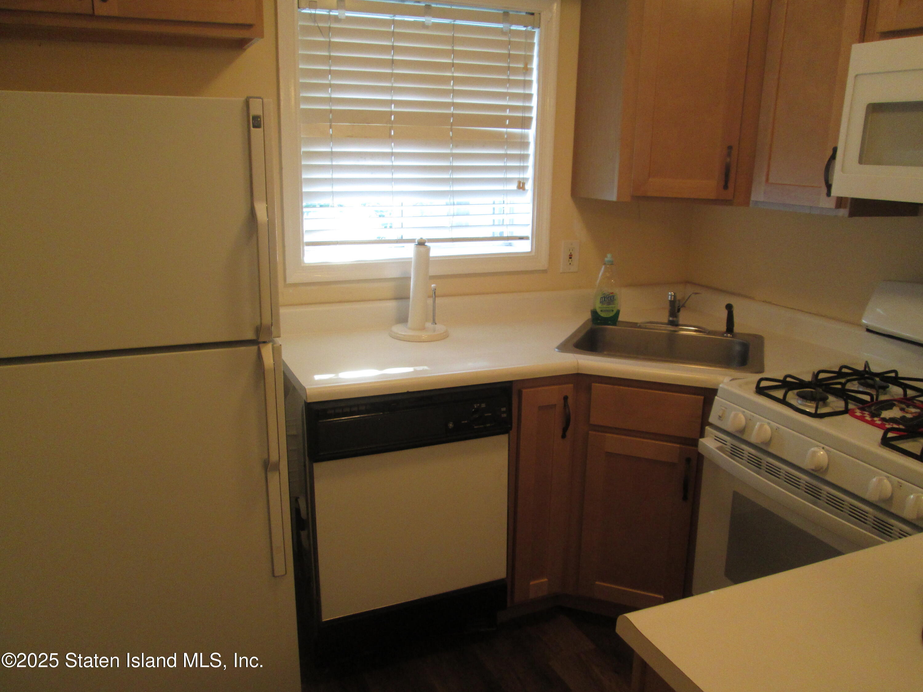 355 Ilyssa Way Staten Island, NY 10312 - Photo 12 of 12 a kitchen with a sink a stove and cabinets