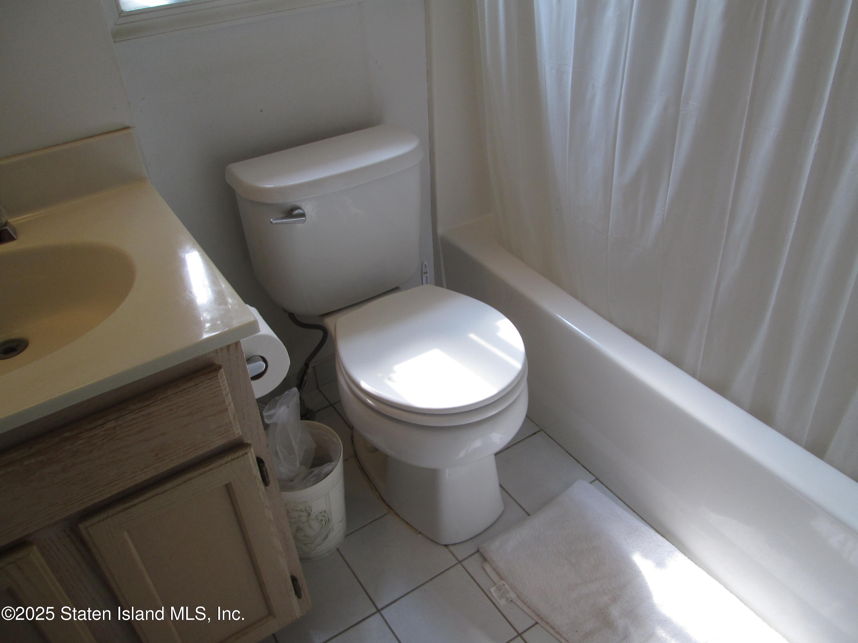 355 Ilyssa Way Staten Island, NY 10312 - Photo 6 of 12 a bathroom with a toilet and a sink