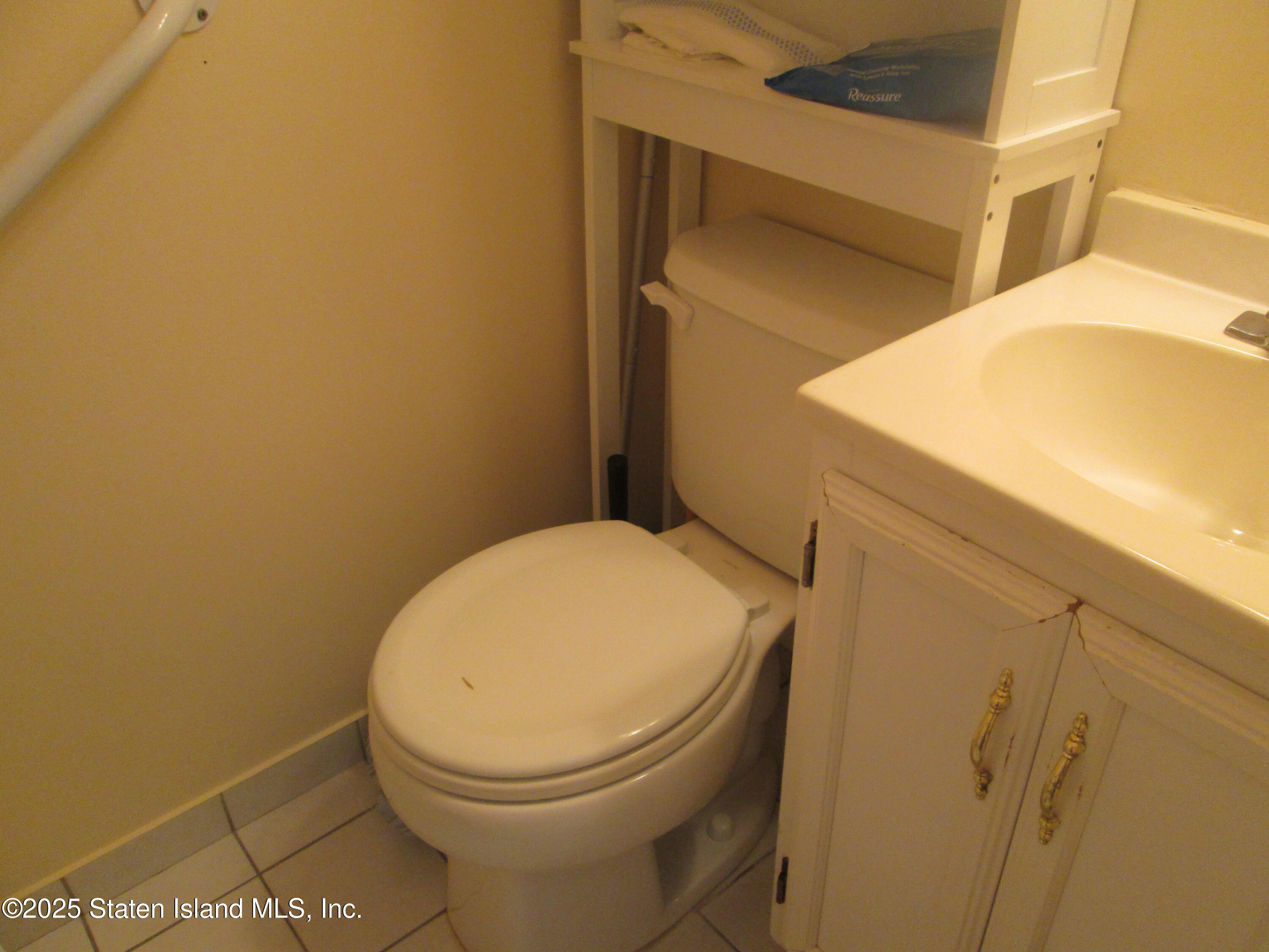 355 Ilyssa Way Staten Island, NY 10312 - Photo 10 of 12 a bathroom with a toilet and a sink
