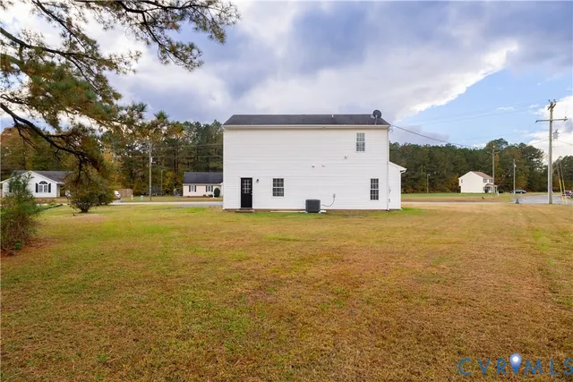 a view of a white house with a yard