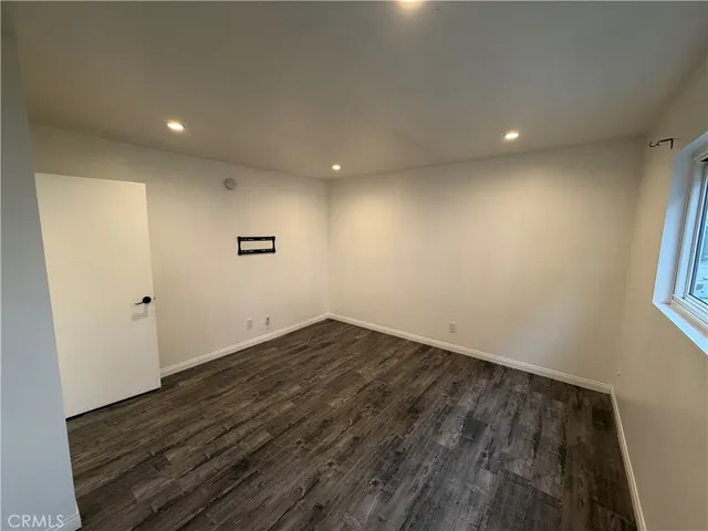 a bathroom with a sink a toilet a mirror and shower