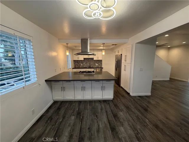 a kitchen with granite countertop a stove and cabinets