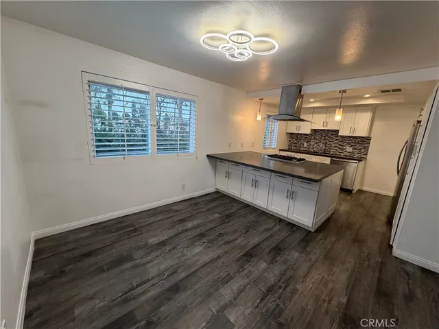 a kitchen with stainless steel appliances granite countertop a refrigerator and a stove