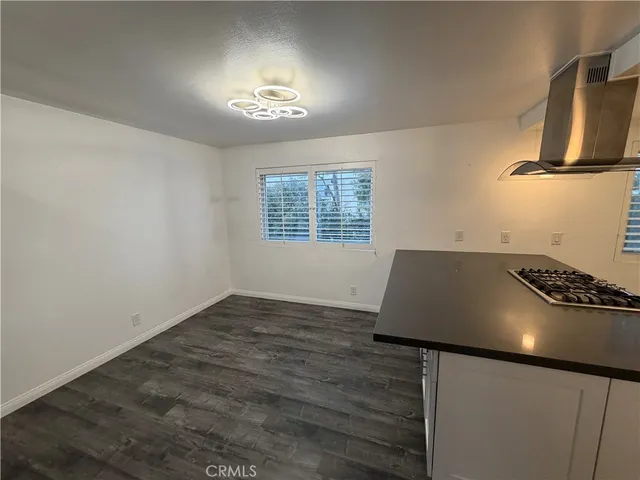 a kitchen with granite countertop a stove and a sink