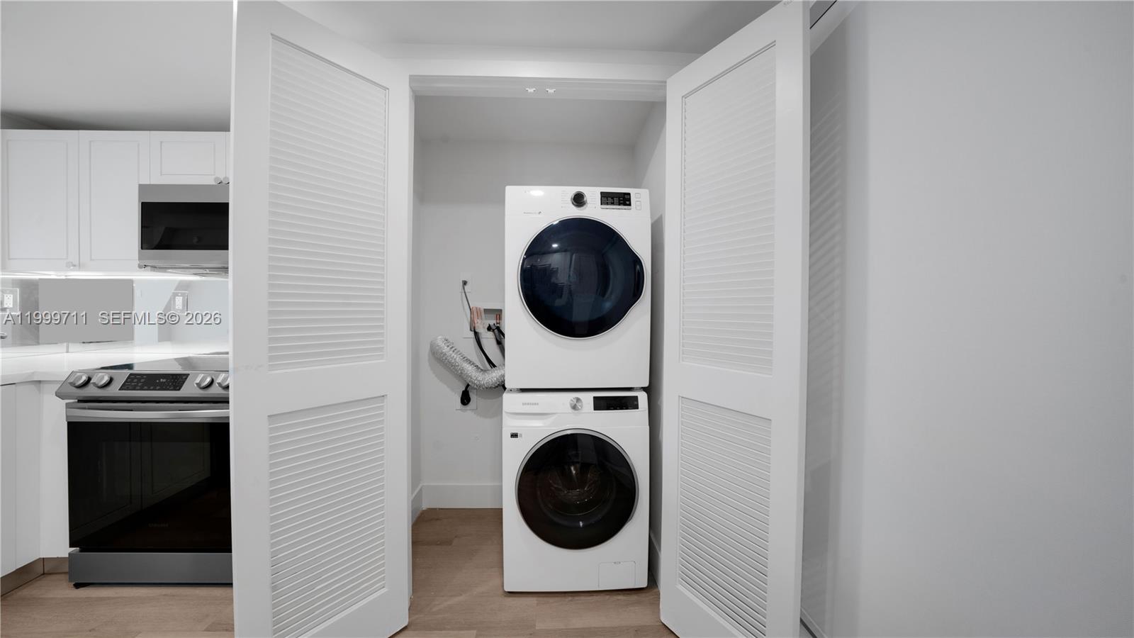 555 Northeast 34th Street, Unit 603 Miami, FL 33137 - Photo 11 of 28 a utility room with sink dryer and washer