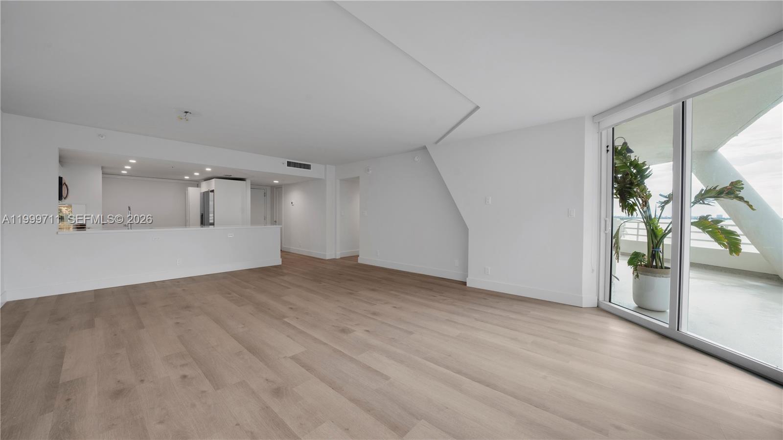 555 Northeast 34th Street, Unit 603 Miami, FL 33137 - Photo 16 of 28 a view of a livingroom with wooden floor and a bathroom