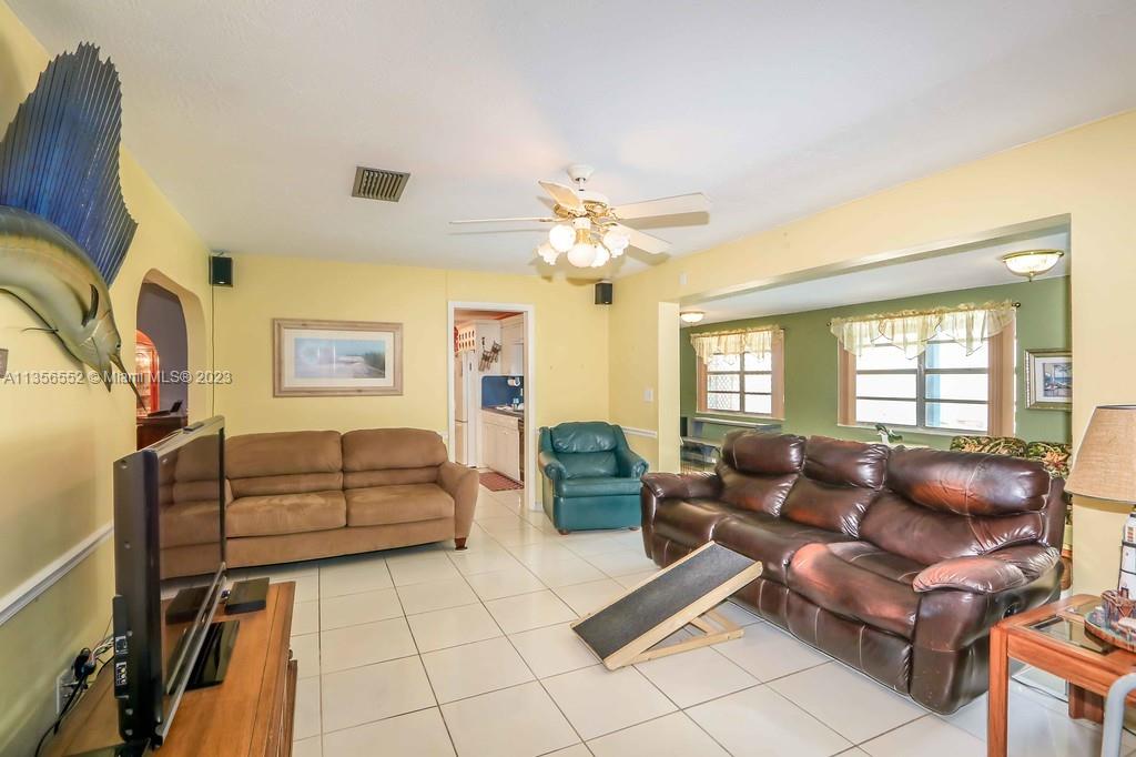 Redlands Homestead, FL 33031 - Photo 11 of 36 a living room with furniture and a chandelier