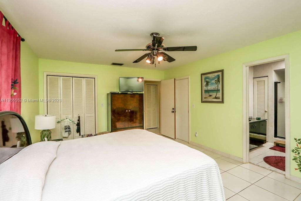 Redlands Homestead, FL 33031 - Photo 15 of 36 a bedroom with a bed and a chandelier