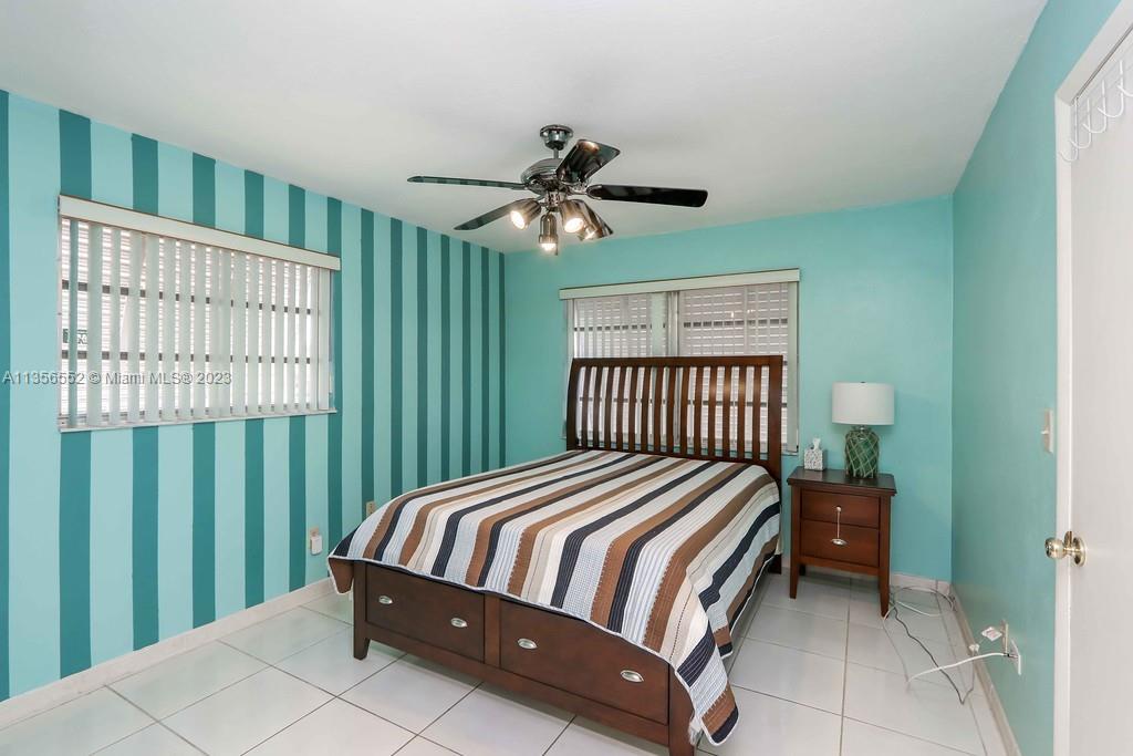 Redlands Homestead, FL 33031 - Photo 17 of 36 a bedroom with a bed and a chandelier