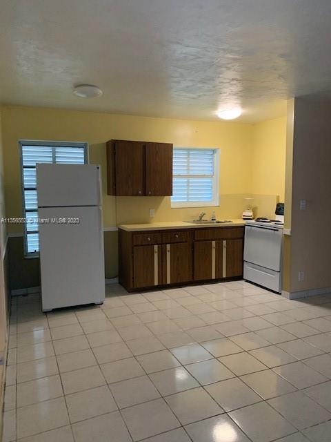 Redlands Homestead, FL 33031 - Photo 22 of 36 a large kitchen with a large counter top and stainless steel appliances