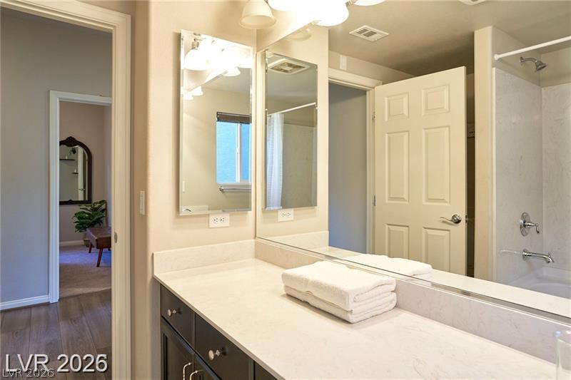 6302 Jackson Spring Road Las Vegas, NV 89118 - Photo 18 of 48 A well-appointed bathroom features ample counter space and an integrated shower-tub.