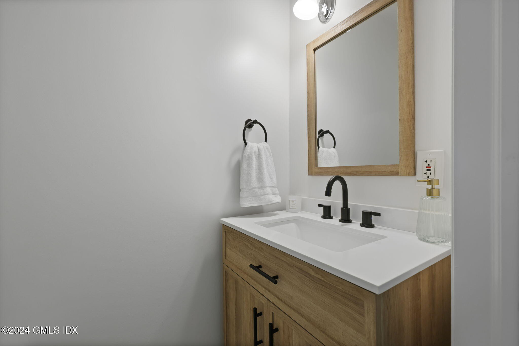 98 Valley Road, Unit 6 Cos Cob, CT 06807 - Photo 5 of 16 a bathroom with a sink and a mirror