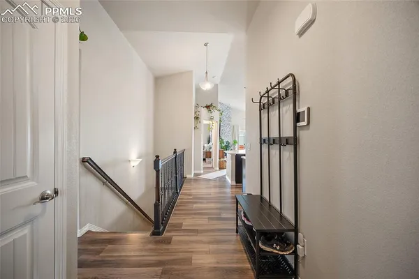 a view of a hallway view with wooden floor and staircase