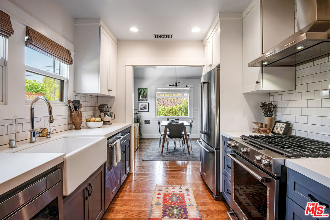 3828 Seneca Avenue Los Angeles, CA 90039 - Photo 11 of 40 a kitchen with a sink stove and cabinets