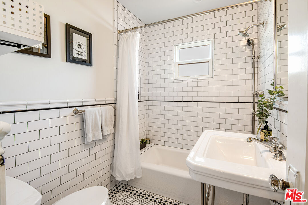 3828 Seneca Avenue Los Angeles, CA 90039 - Photo 17 of 40 a bathroom with a sink a toilet and shower
