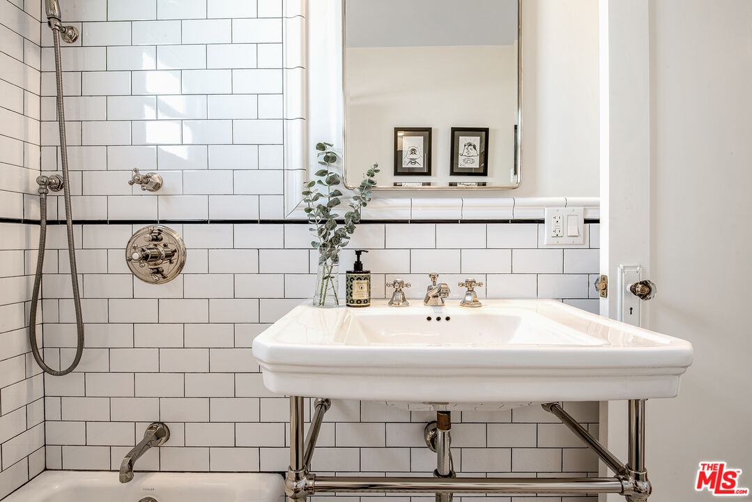 3828 Seneca Avenue Los Angeles, CA 90039 - Photo 18 of 40 a bathroom with a sink a mirror and vanity