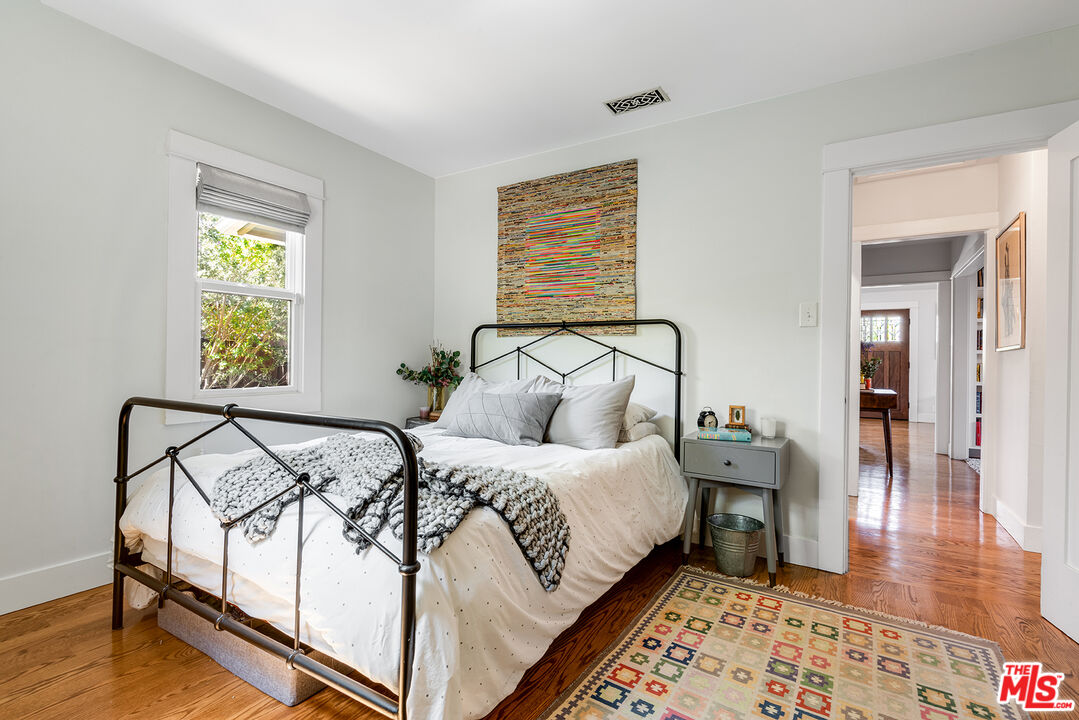 3828 Seneca Avenue Los Angeles, CA 90039 - Photo 19 of 40 a bedroom with a bed and wooden floor