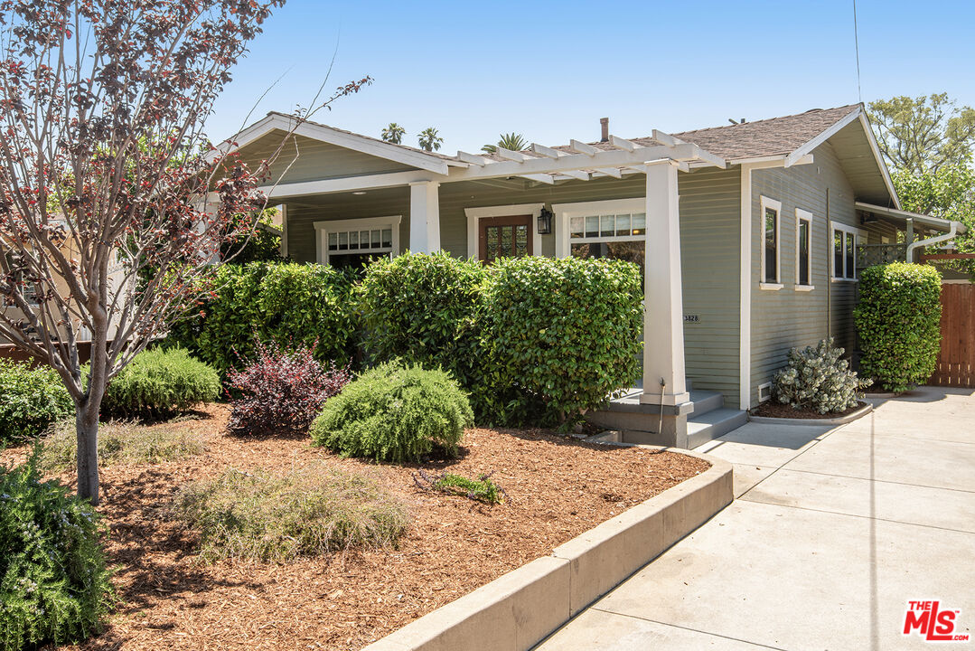 3828 Seneca Avenue Los Angeles, CA 90039 - Photo 2 of 40 a view of a white house with a yard and potted plants