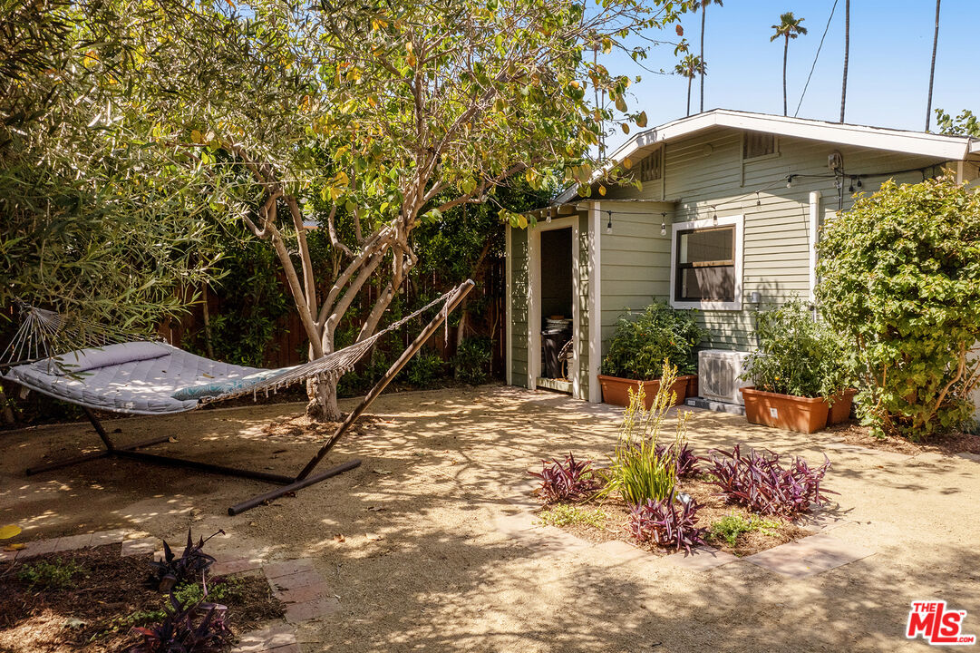 3828 Seneca Avenue Los Angeles, CA 90039 - Photo 33 of 40 a view of a backyard with table and chairs under an umbrella