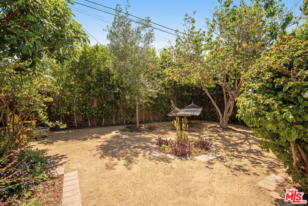 3828 Seneca Avenue Los Angeles, CA 90039 - Photo 34 of 40 a wooden bench sitting in the middle of a yard