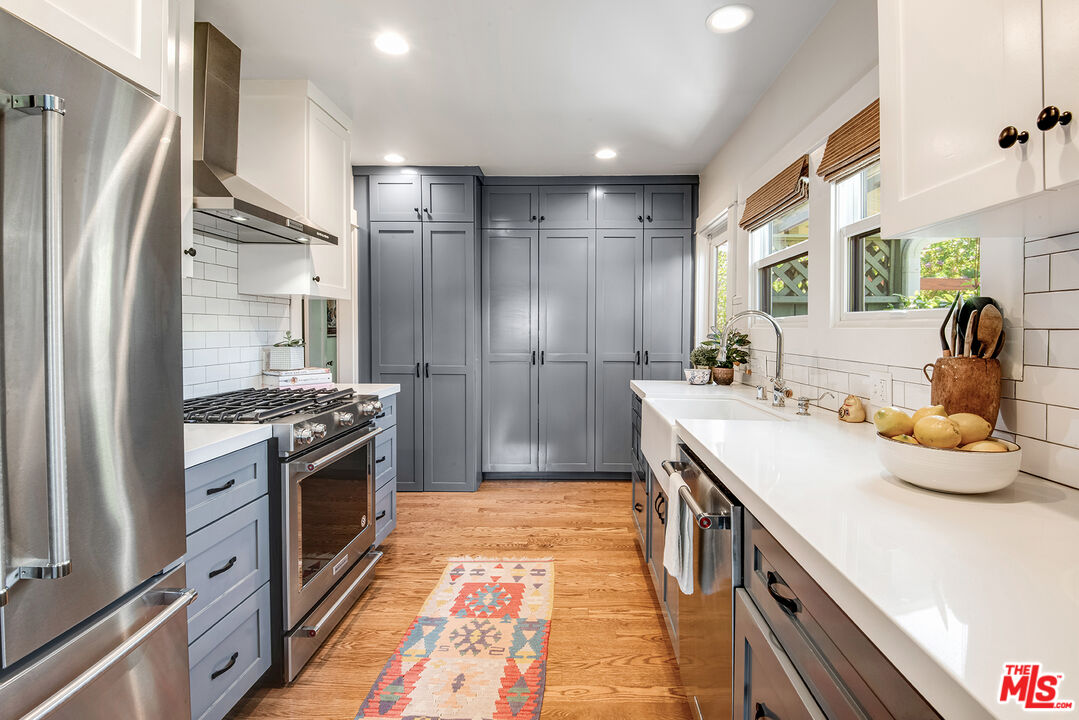 3828 Seneca Avenue Los Angeles, CA 90039 - Photo 9 of 40 a kitchen with kitchen island granite countertop a sink stove and refrigerator