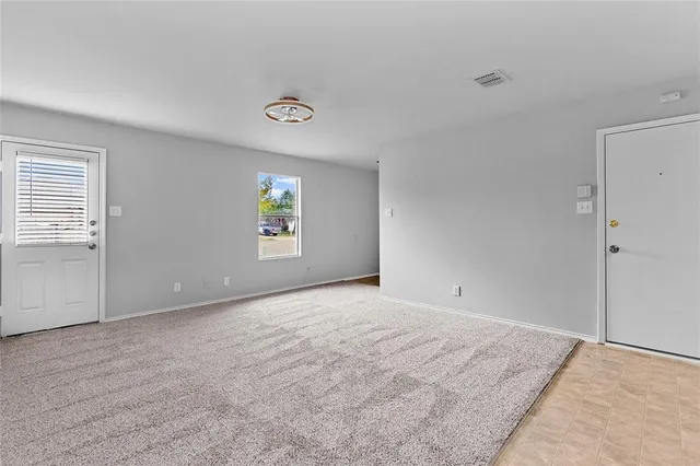 an empty room with windows and closet