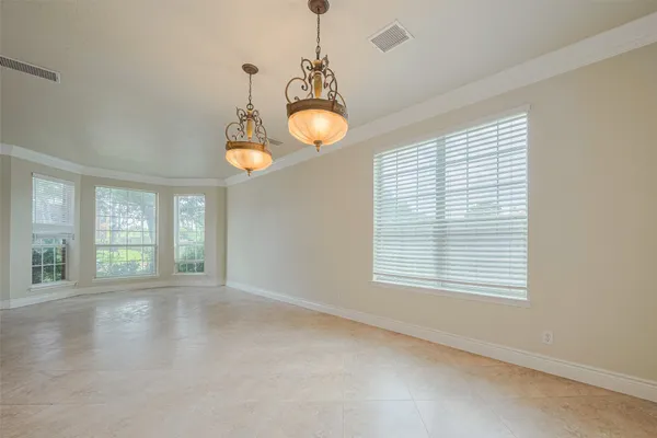 a view of a hallway with wooden floor and a bathroom
