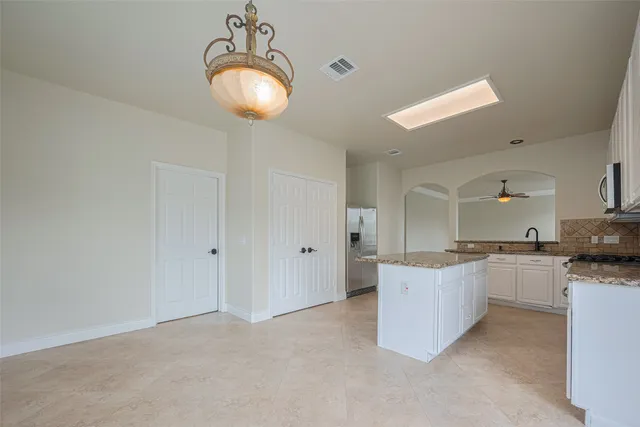 a view of workspace with wooden floor and a ceiling fan