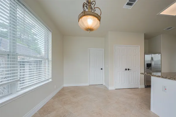 a view of an empty room and wooden floor