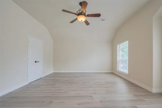 a spacious bathroom with a granite countertop sink mirror and a shower