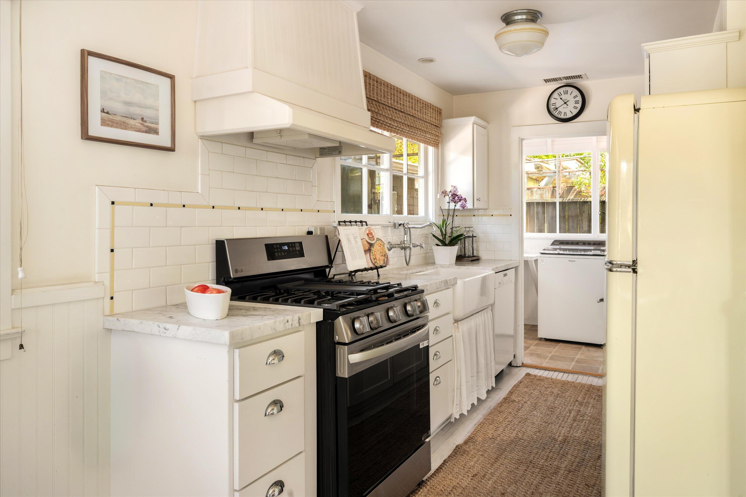 601 East Victoria Street Santa Barbara, CA 93103 - Photo 12 of 32 a kitchen with a stove and a refrigerator