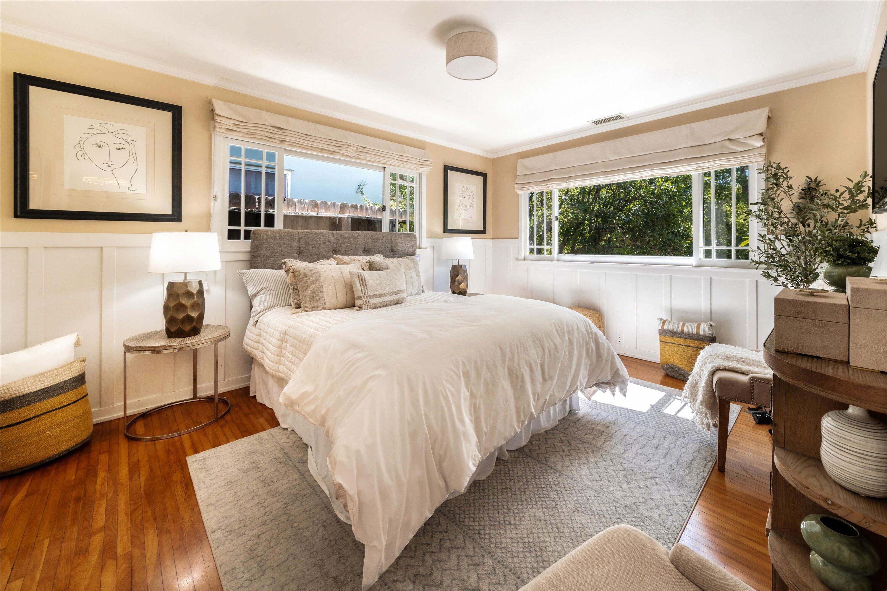 601 East Victoria Street Santa Barbara, CA 93103 - Photo 13 of 32 a bedroom with a bed and large windows