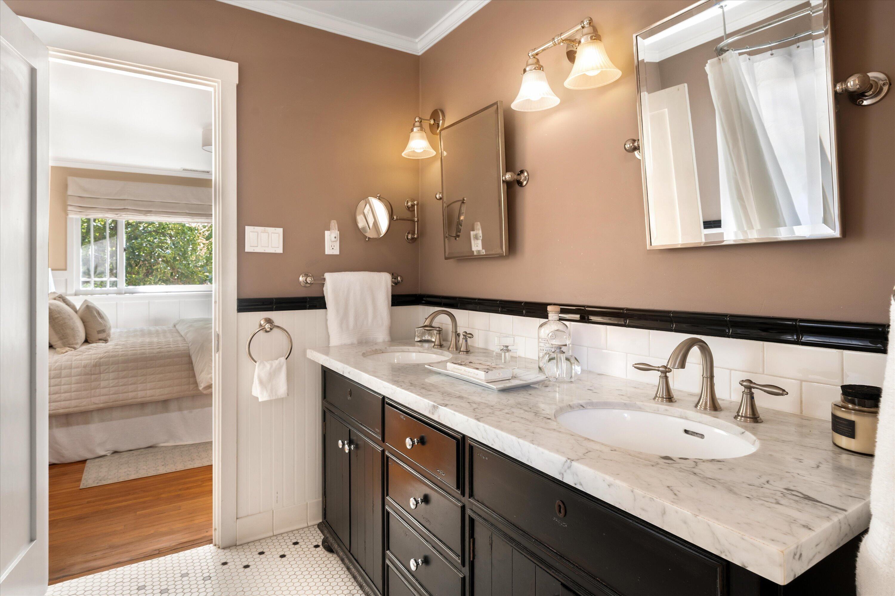 601 East Victoria Street Santa Barbara, CA 93103 - Photo 14 of 32 a bathroom with a granite countertop sink and a mirror