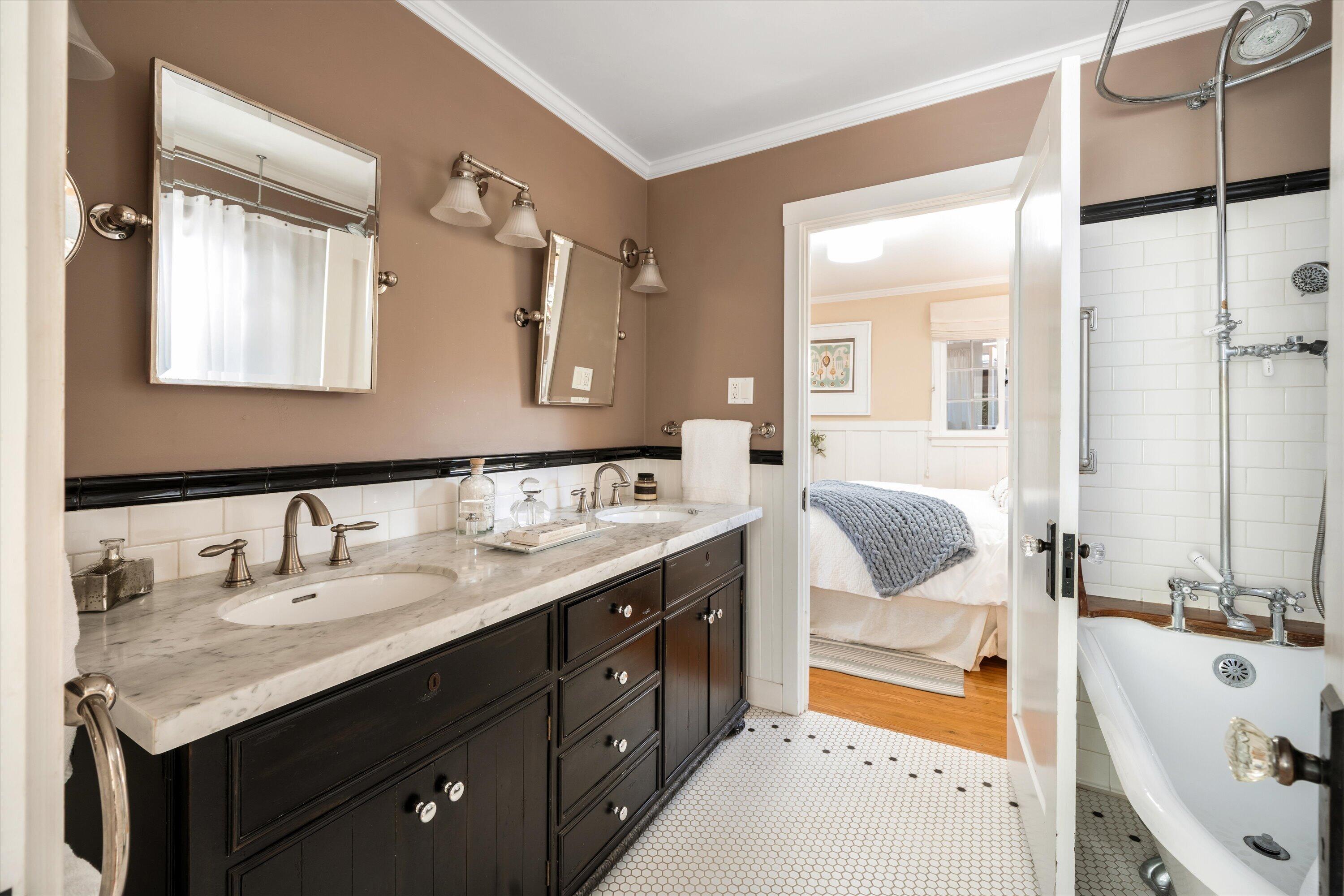 601 East Victoria Street Santa Barbara, CA 93103 - Photo 15 of 32 a en suite bathroom with a tub double sink and mirror