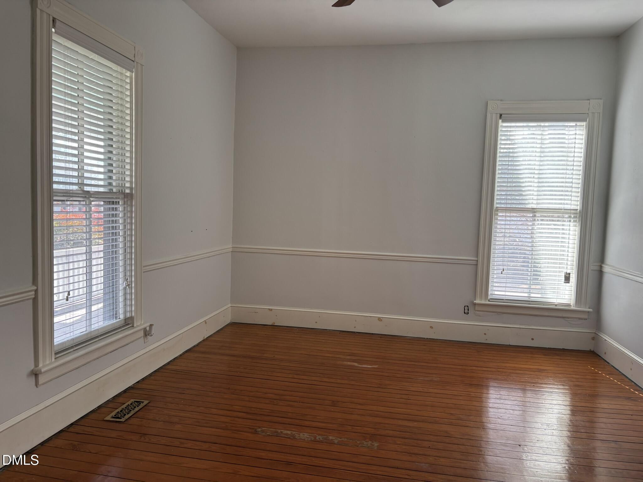 401 North Main Street Louisburg, NC 27549 - Photo 10 of 47 wooden floor in an empty room with a window