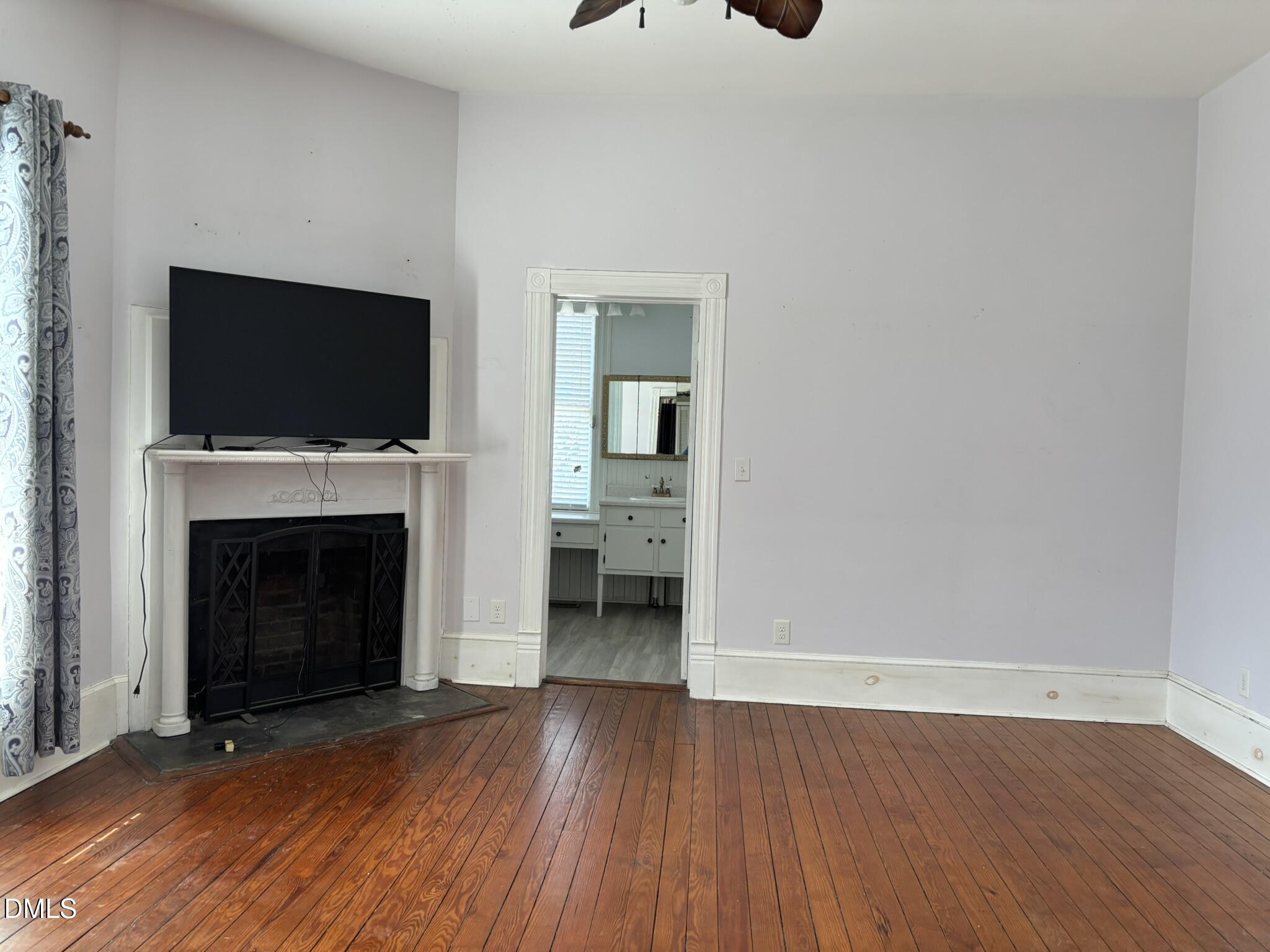 401 North Main Street Louisburg, NC 27549 - Photo 11 of 47 a view of an empty room with wooden floor and a fireplace