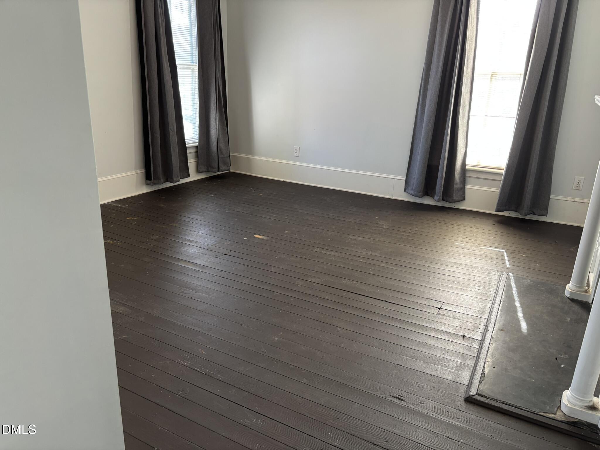 401 North Main Street Louisburg, NC 27549 - Photo 21 of 47 an empty room with wooden floor and windows