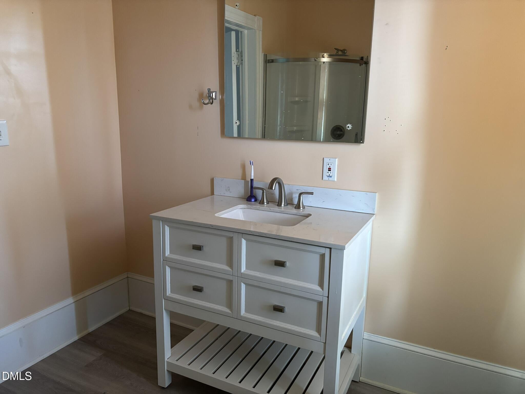 401 North Main Street Louisburg, NC 27549 - Photo 24 of 47 a bathroom with a sink and a mirror
