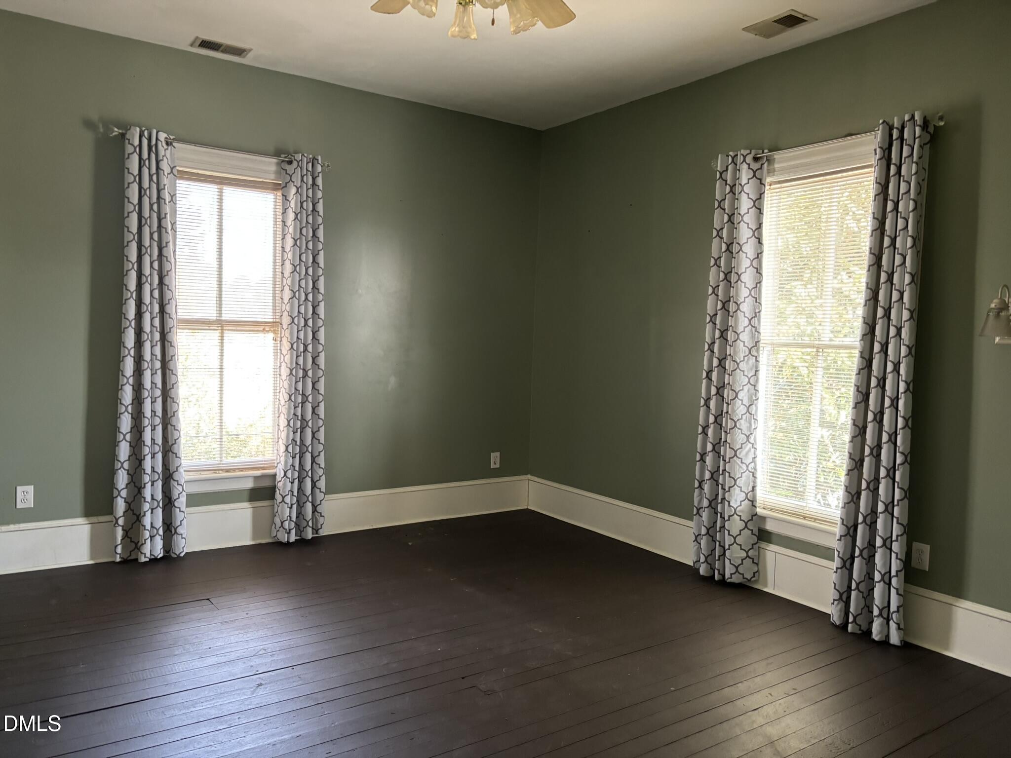 401 North Main Street Louisburg, NC 27549 - Photo 25 of 47 an empty room with wooden floor and windows