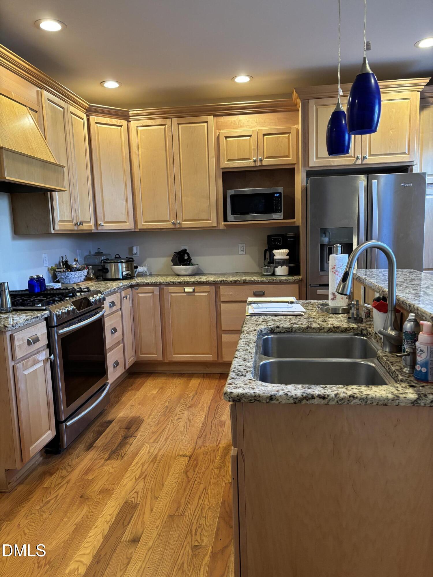 401 North Main Street Louisburg, NC 27549 - Photo 37 of 47 a kitchen with stainless steel appliances granite countertop a sink stove and cabinets