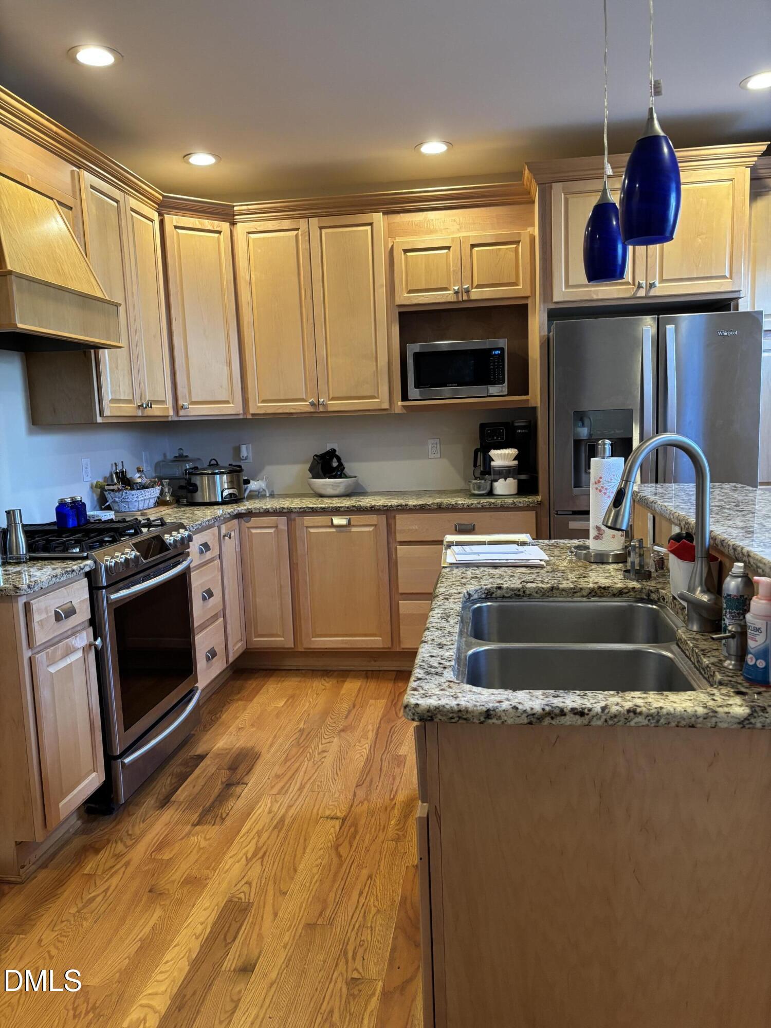 401 North Main Street Louisburg, NC 27549 - Photo 38 of 47 a kitchen with kitchen island granite countertop a sink stainless steel appliances and cabinets