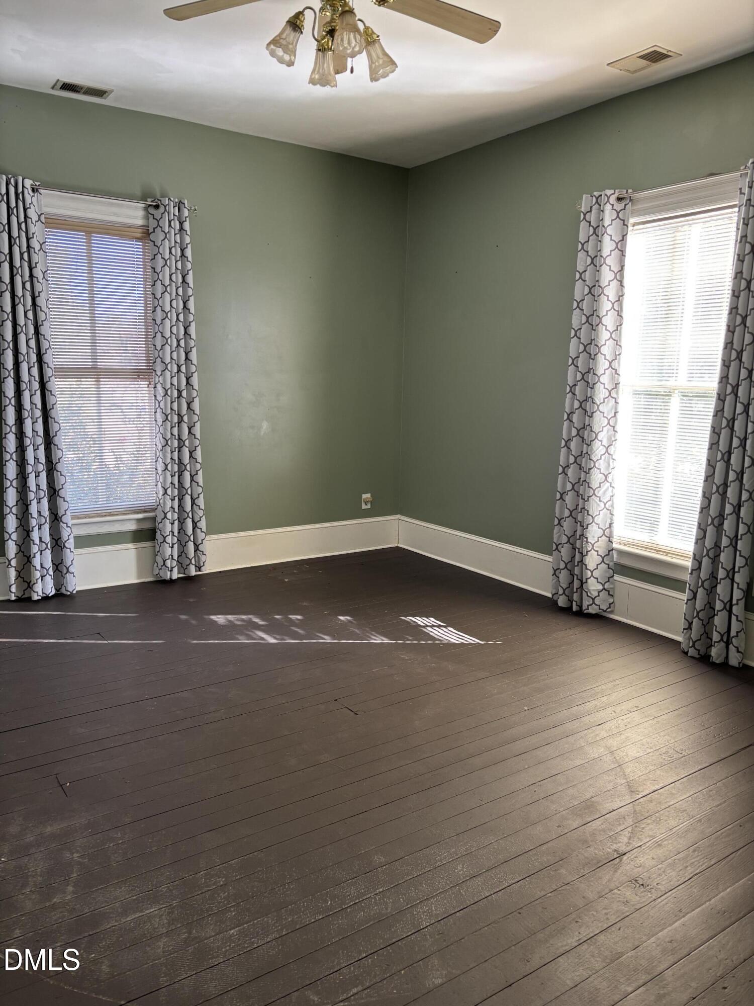 401 North Main Street Louisburg, NC 27549 - Photo 40 of 47 an empty room with wooden floor and windows